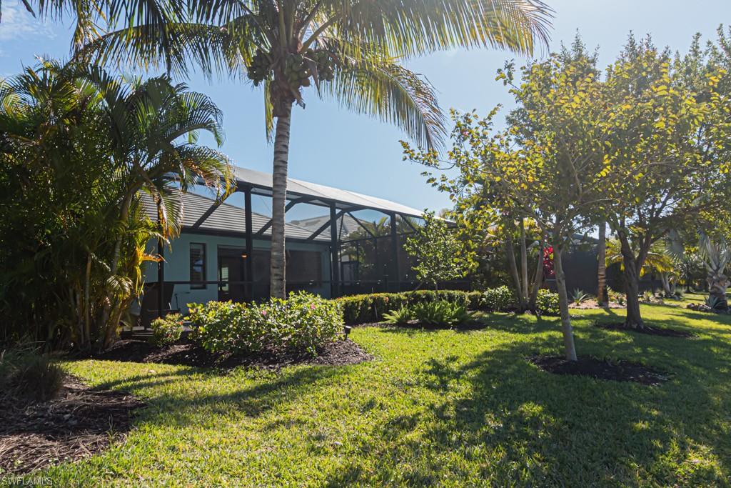 1869 Mustique Street Naples, FL 34120 - Photo 29 of 48 a view of a house with a yard and potted plants