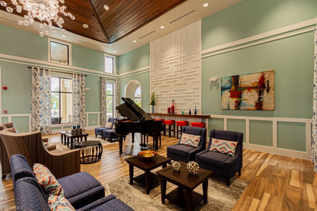 1869 Mustique Street Naples, FL 34120 - Photo 44 of 48 a living room with furniture and a wooden floor