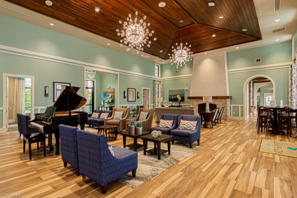 1869 Mustique Street Naples, FL 34120 - Photo 45 of 48 a living room with lots of furniture and a chandelier
