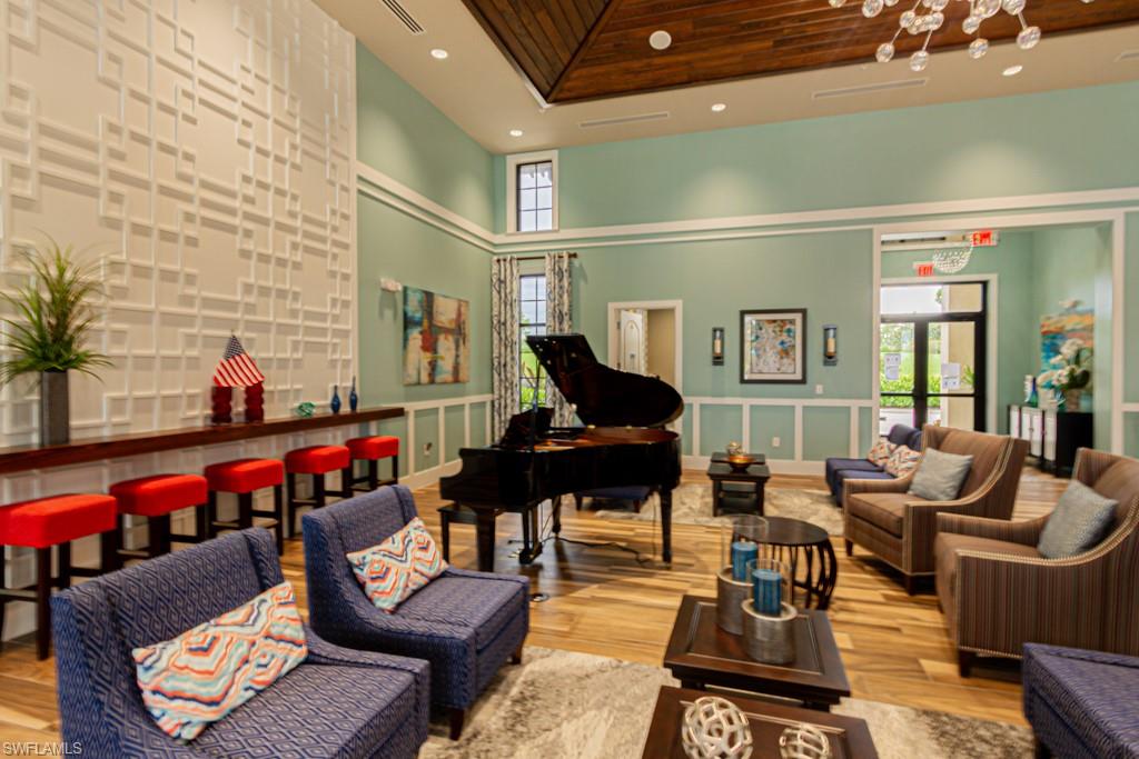 1869 Mustique Street Naples, FL 34120 - Photo 46 of 48 a living room with furniture and wooden floor