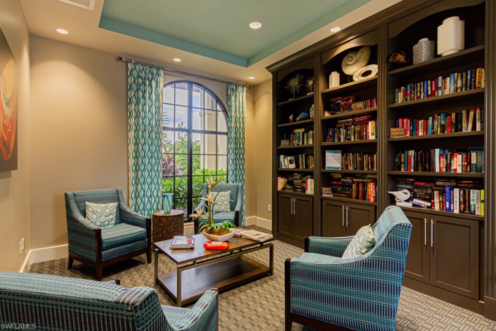 1869 Mustique Street Naples, FL 34120 - Photo 47 of 48 a living room with furniture and a book shelf