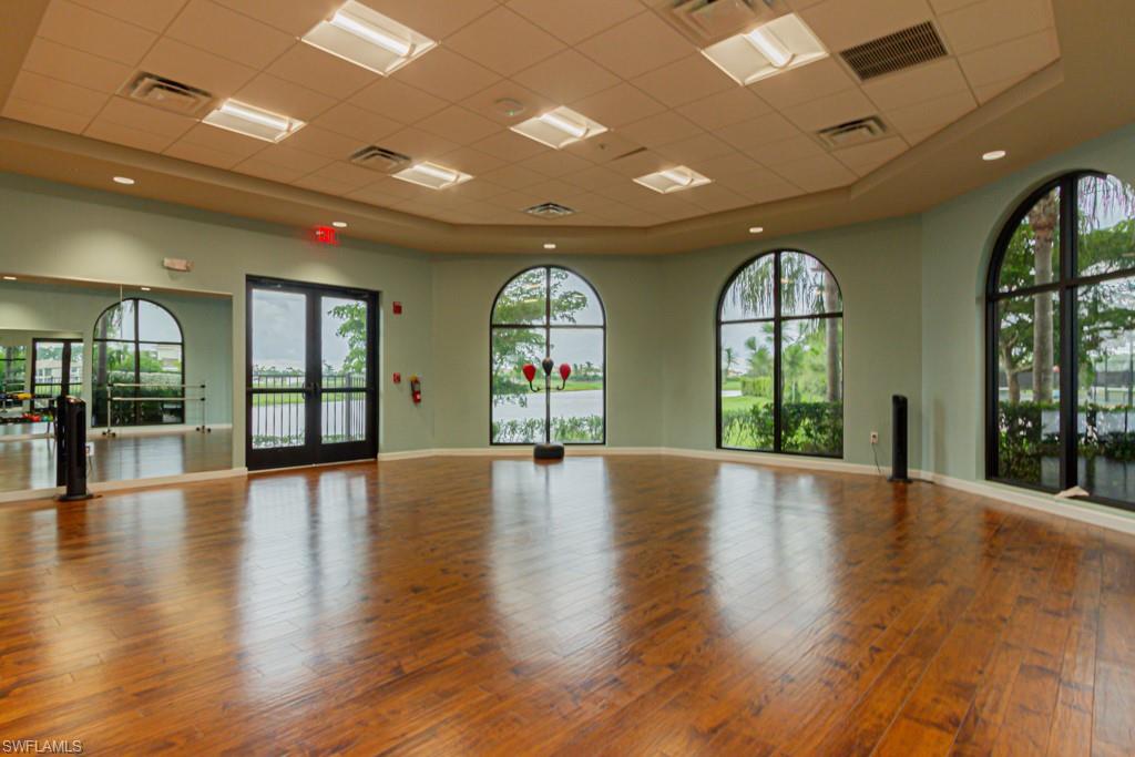 1869 Mustique Street Naples, FL 34120 - Photo 48 of 48 an empty room with wooden floor and a large window