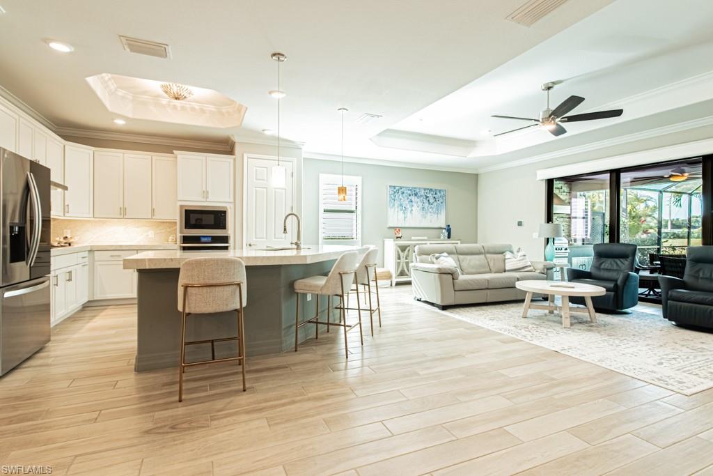 1869 Mustique Street Naples, FL 34120 - Photo 7 of 48 a living room with stainless steel appliances furniture and a kitchen view