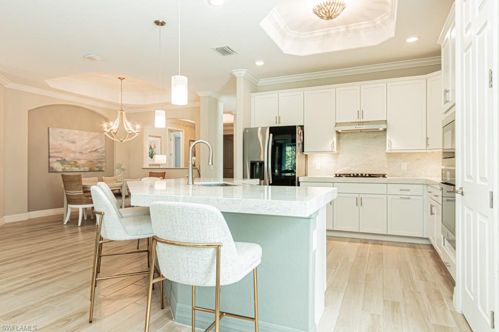1869 Mustique Street Naples, FL 34120 - Photo 10 of 48 a kitchen with counter top space and appliances