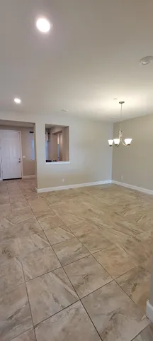 a view of kitchen with refrigerator and window