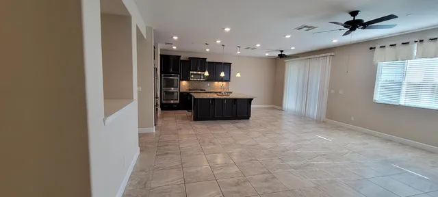 a large kitchen with kitchen island granite countertop lots of counter top space