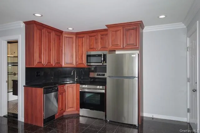a kitchen with stainless steel appliances granite countertop a refrigerator and a stove top oven