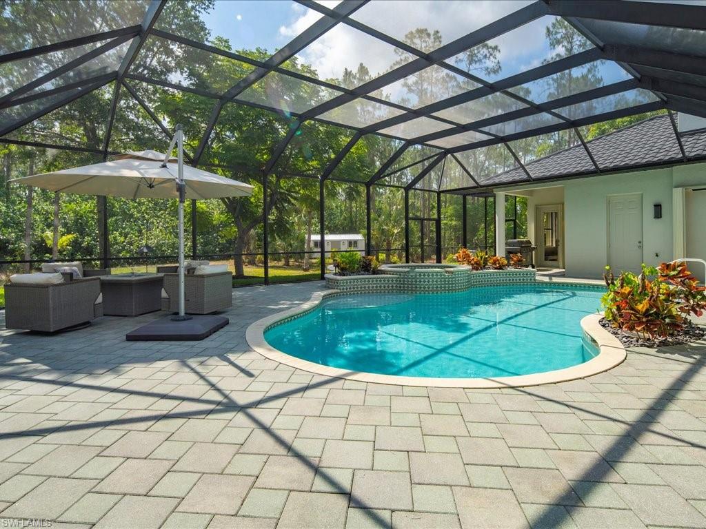 2360 19th Street Southwest Naples, FL 34117 - Photo 11 of 50 View of swimming pool featuring a patio area, an outdoor hangout area, a pool with connected hot tub, and glass enclosure
