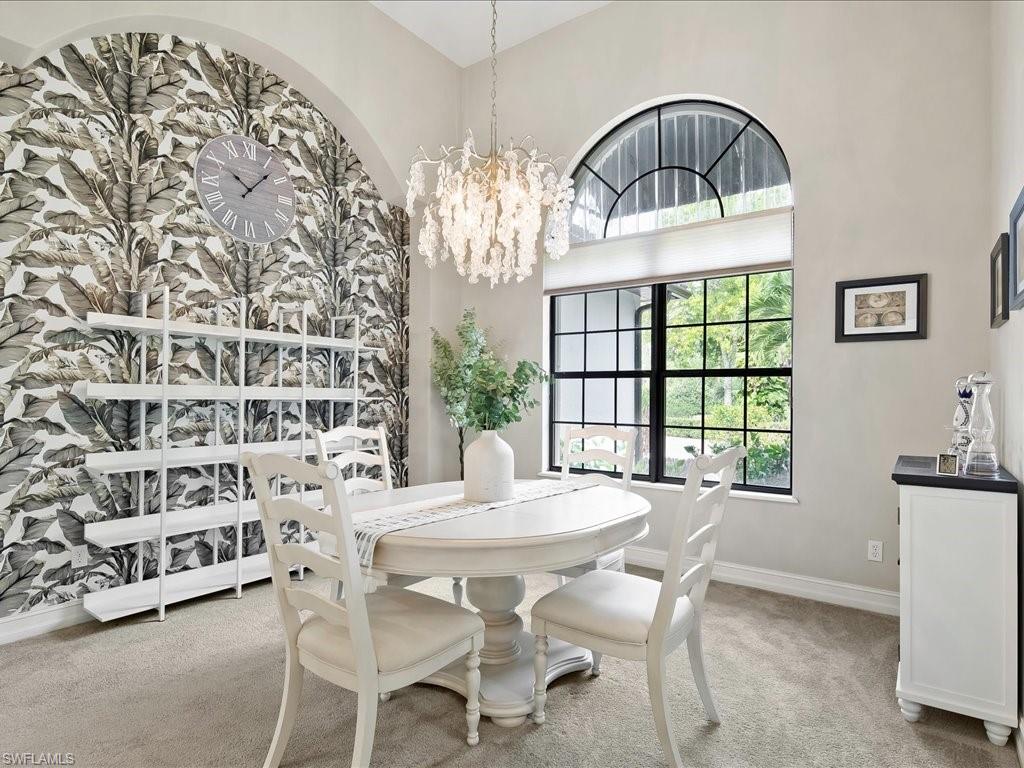 2360 19th Street Southwest Naples, FL 34117 - Photo 15 of 50 Dining room featuring light carpet, a chandelier, and baseboards