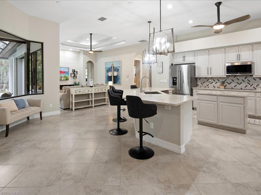 2360 19th Street Southwest Naples, FL 34117 - Photo 16 of 50 Kitchen with appliances with stainless steel finishes, a ceiling fan, arched walkways, a sink, and recessed lighting
