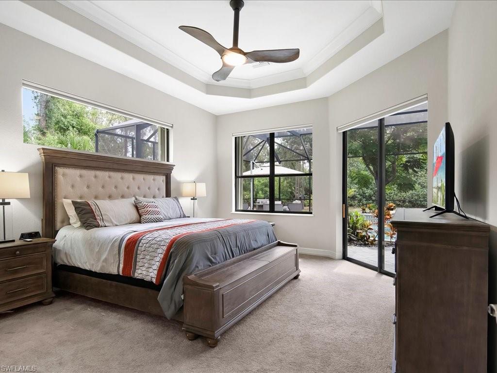 2360 19th Street Southwest Naples, FL 34117 - Photo 27 of 50 Bedroom with access to exterior, light colored carpet, multiple windows, ornamental molding, and a raised ceiling