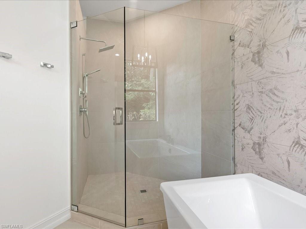 2360 19th Street Southwest Naples, FL 34117 - Photo 31 of 50 Bathroom with a soaking tub and a stall shower