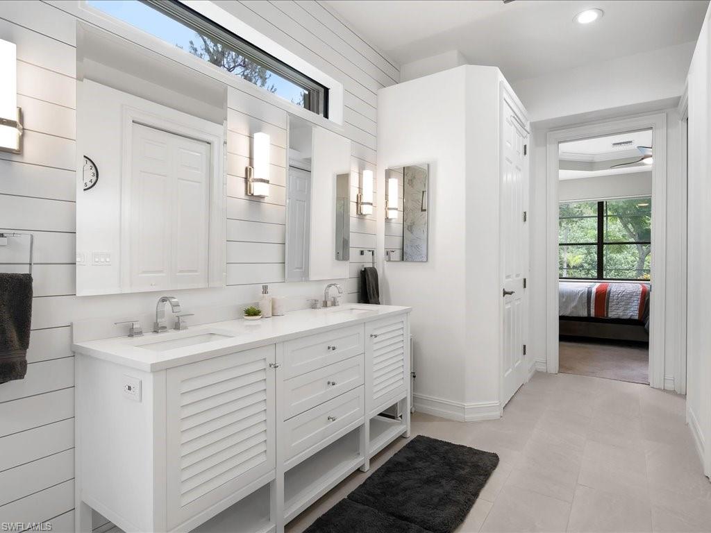 2360 19th Street Southwest Naples, FL 34117 - Photo 32 of 50 Bathroom with double vanity, ensuite bathroom, recessed lighting, and baseboards