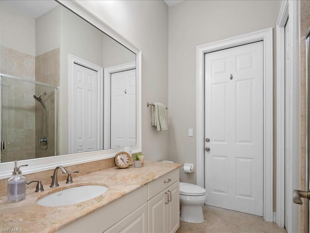 2360 19th Street Southwest Naples, FL 34117 - Photo 35 of 50 Bathroom with vanity, a shower stall, toilet, and tile patterned floors