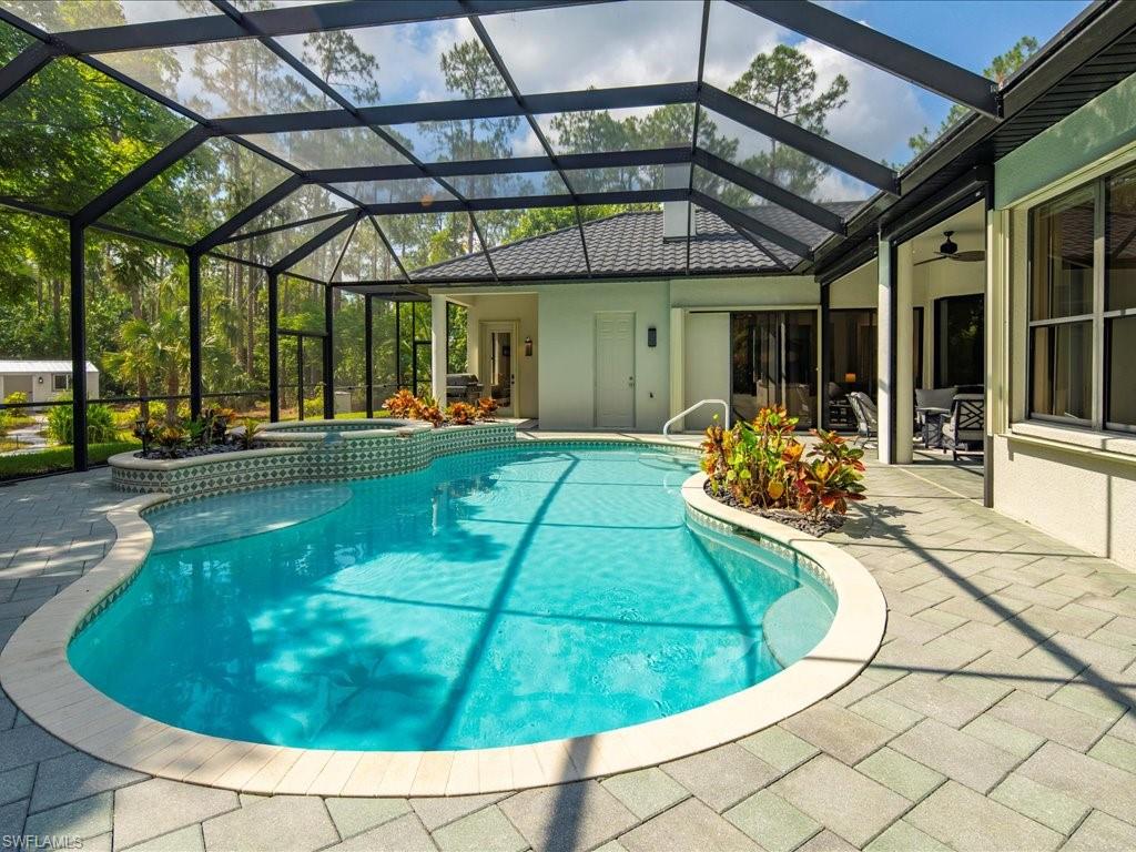 2360 19th Street Southwest Naples, FL 34117 - Photo 45 of 50 View of swimming pool featuring a patio area, a pool with connected hot tub, and a lanai