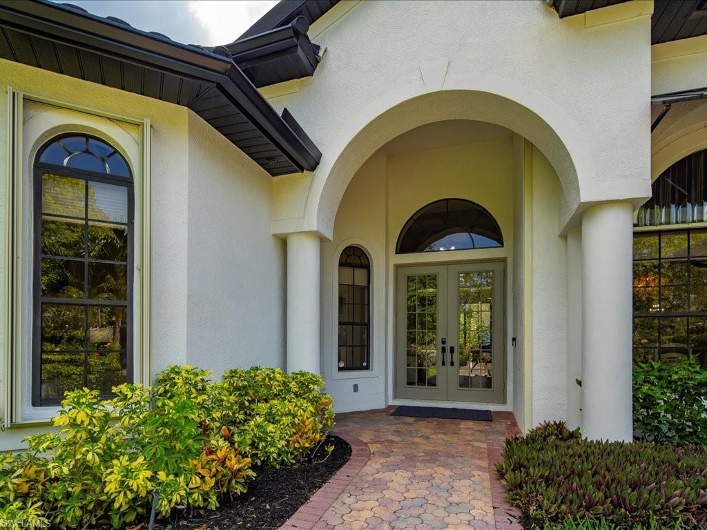 2360 19th Street Southwest Naples, FL 34117 - Photo 5 of 50 Doorway to property with french doors and stucco siding