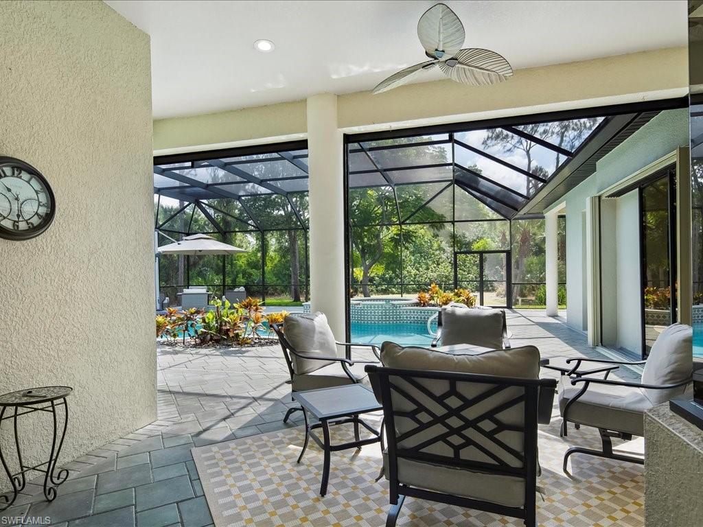 2360 19th Street Southwest Naples, FL 34117 - Photo 6 of 50 View of patio / terrace with a ceiling fan, outdoor lounge area, a pool with connected hot tub, and glass enclosure