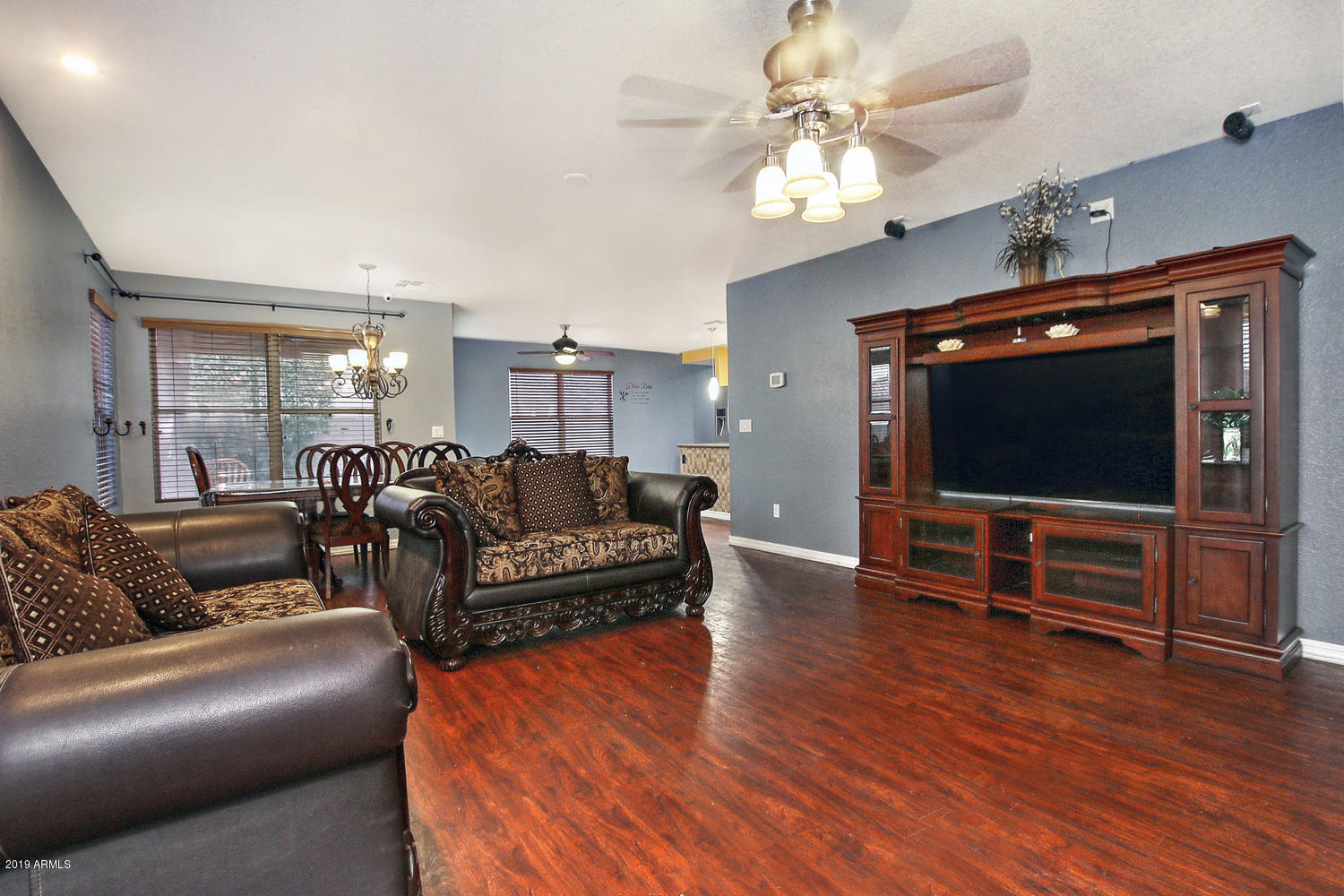 3288 South Chaparral Road Apache Junction, AZ 85119 - Photo 6 of 29 a living room with furniture a flat screen tv and wooden floor