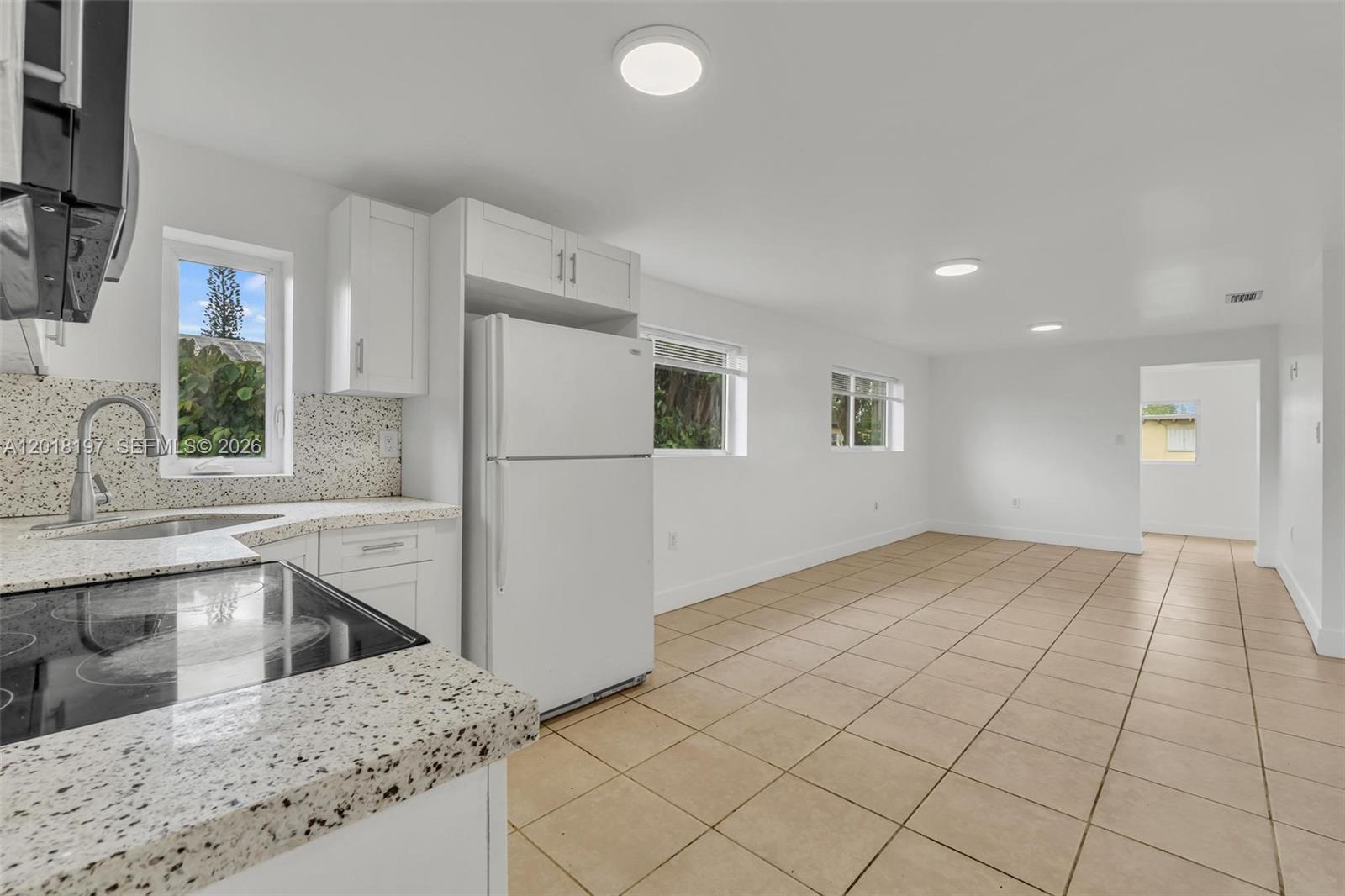 628 Southwest 8th Avenue Homestead, FL 33030 - Photo 14 of 25 a kitchen with a sink a stove and cabinets