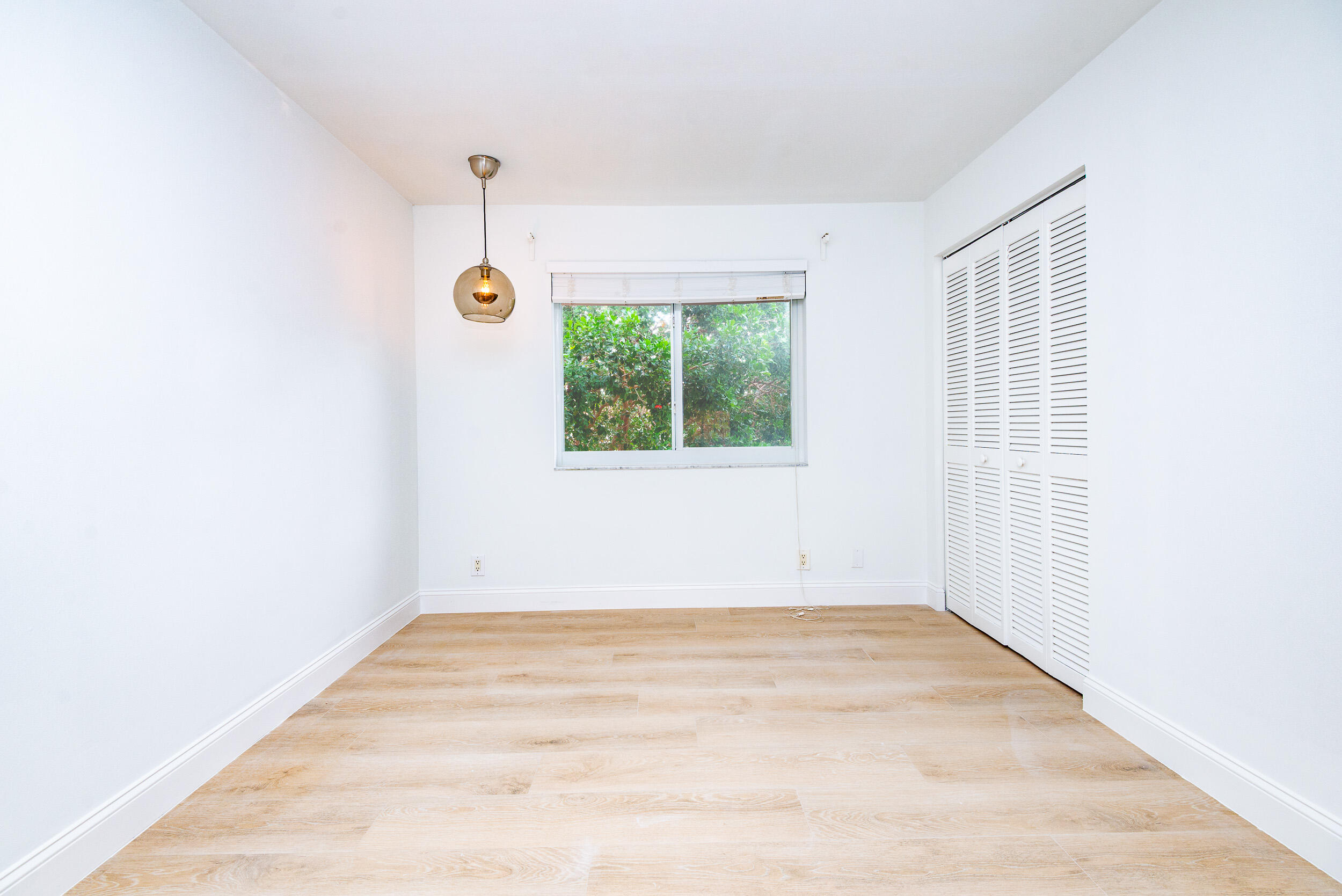 380 Northwest 67th Street, Unit J204 Boca Raton, FL 33487 - Photo 18 of 43 an empty room with a window