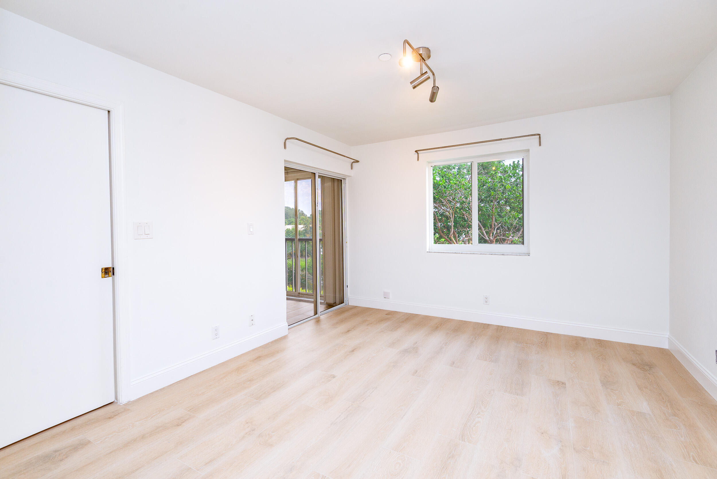 380 Northwest 67th Street, Unit J204 Boca Raton, FL 33487 - Photo 22 of 43 an empty room with windows and closet