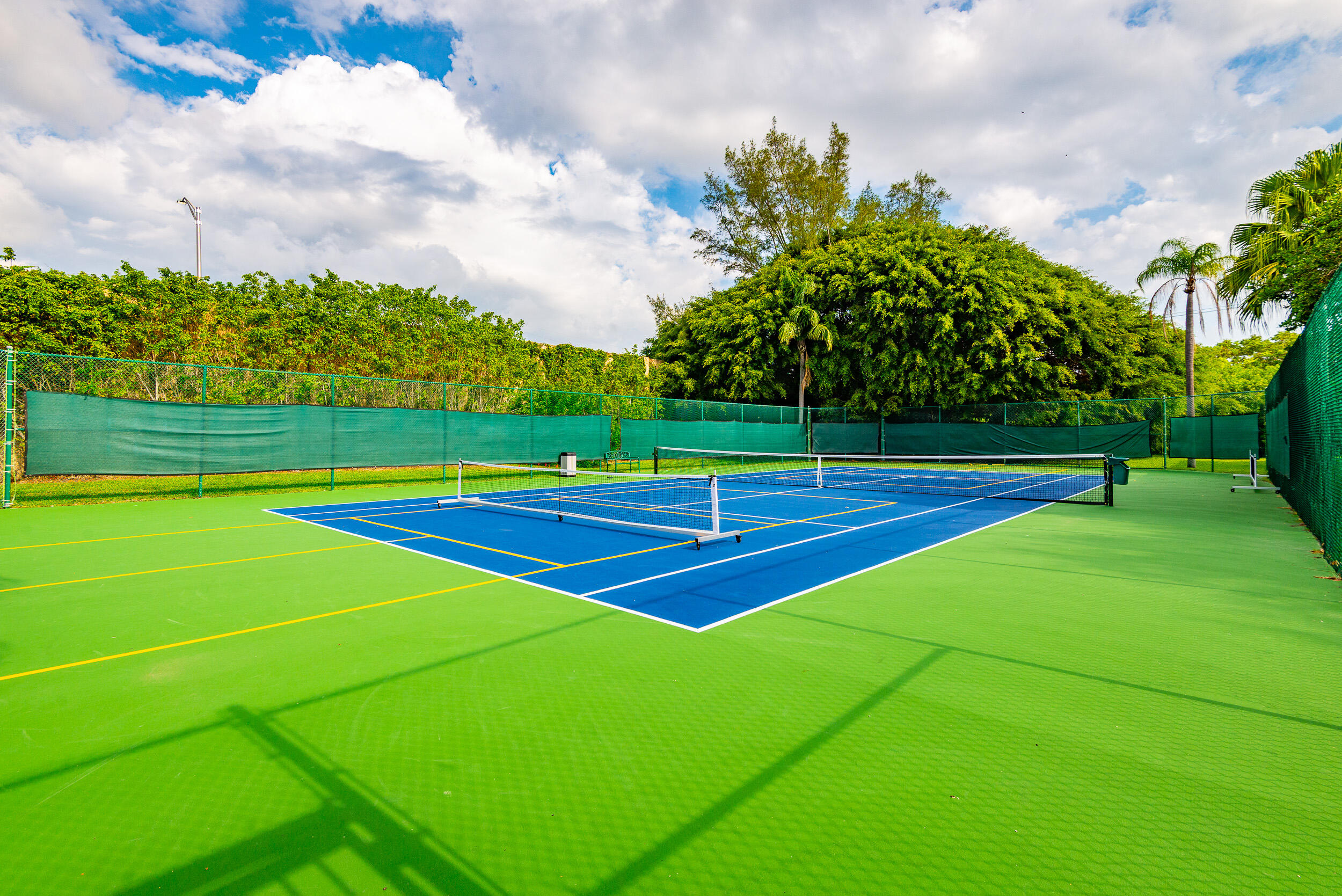 380 Northwest 67th Street, Unit J204 Boca Raton, FL 33487 - Photo 34 of 43 a view of an outdoor space and tennis court