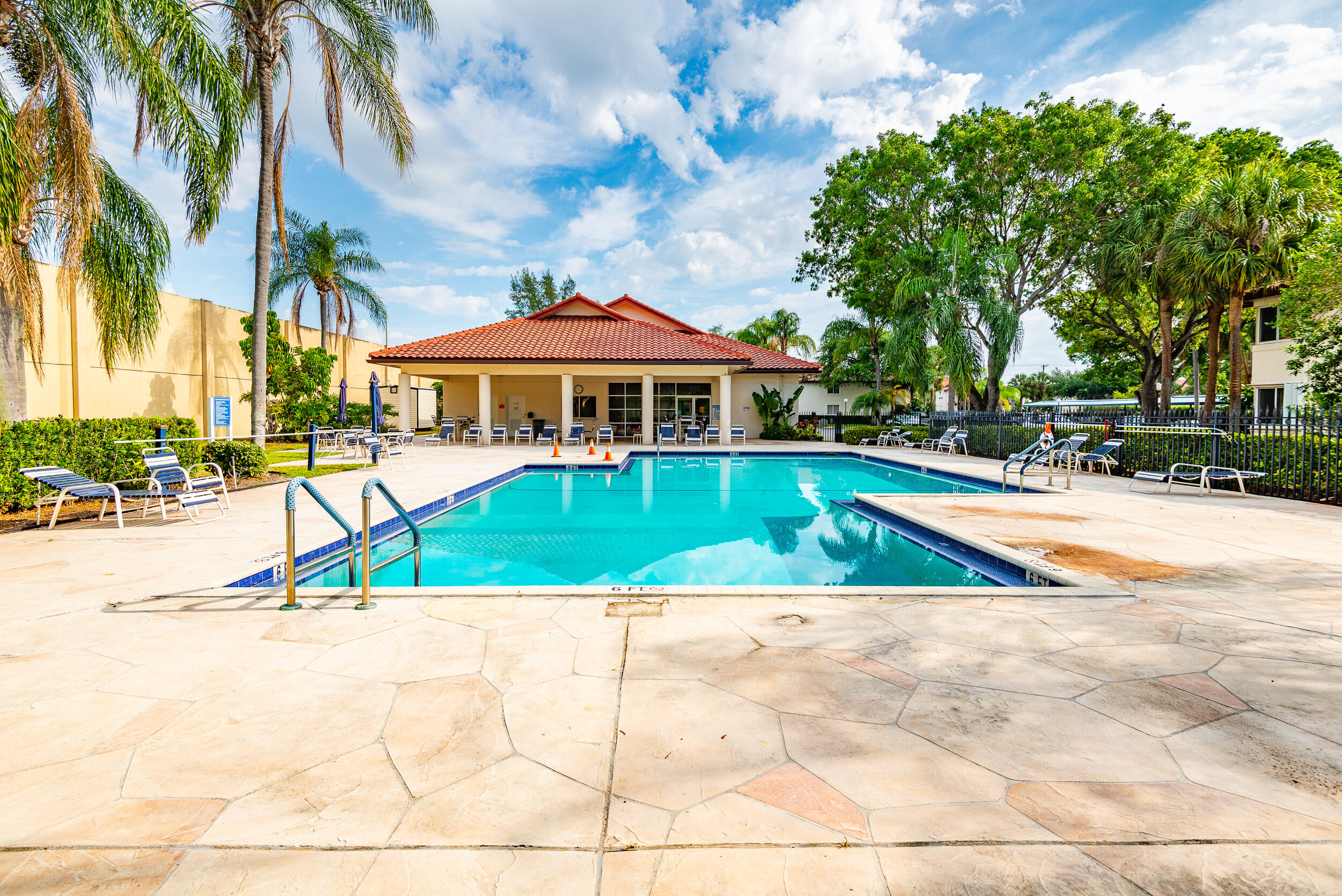 380 Northwest 67th Street, Unit J204 Boca Raton, FL 33487 - Photo 38 of 43 a view of swimming pool and lounge area