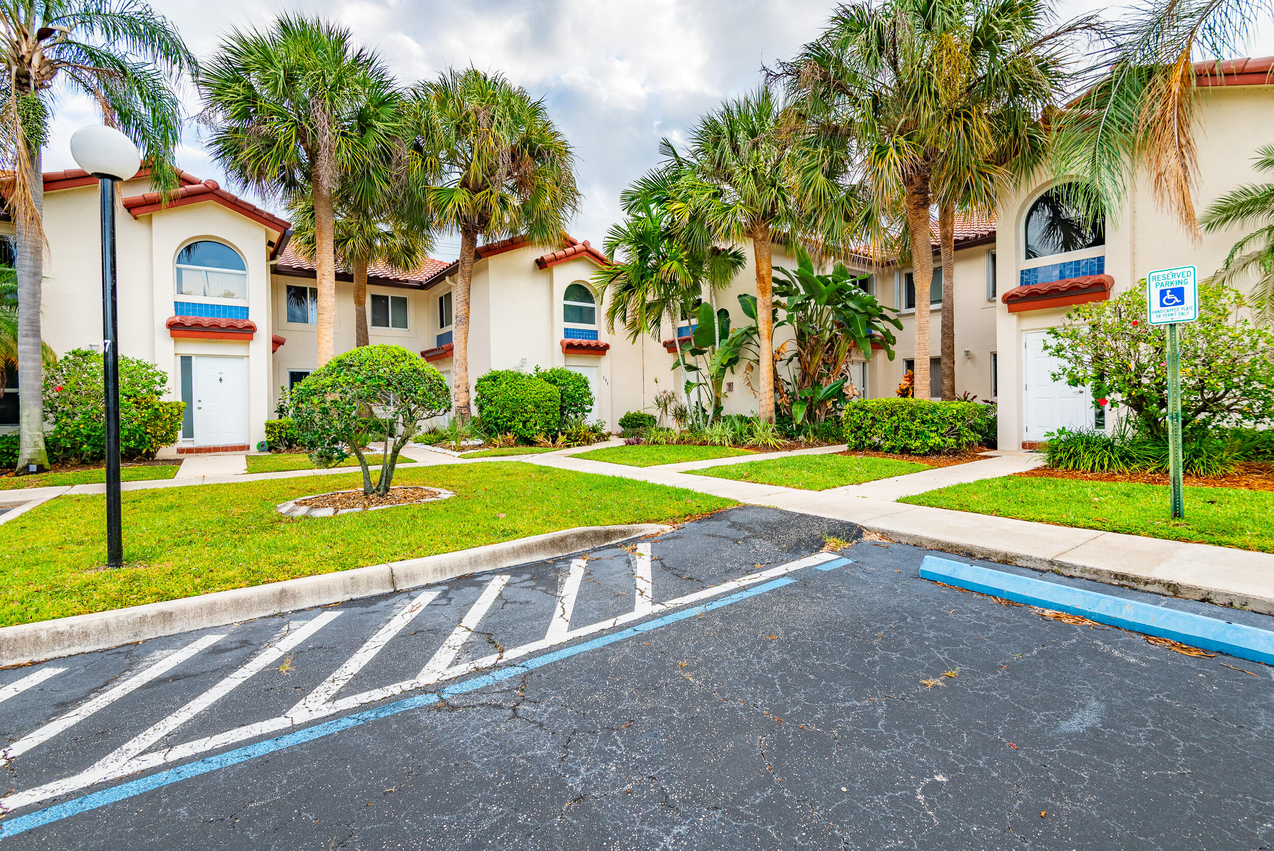 380 Northwest 67th Street, Unit J204 Boca Raton, FL 33487 - Photo 41 of 43 a view of a house with a swimming pool and a yard