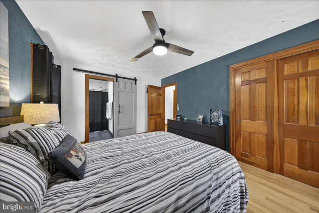 a bathroom with a sink a toilet a mirror a bathtub and shower