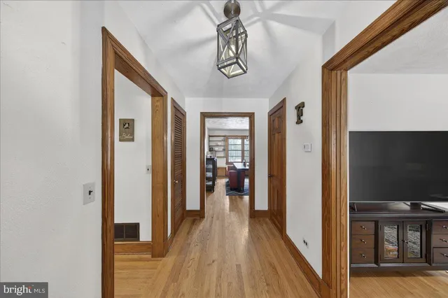 a view of a hallway view with wooden floor and staircase