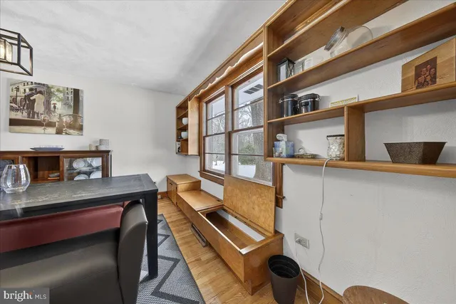 a living room with fireplace furniture and a wooden floor