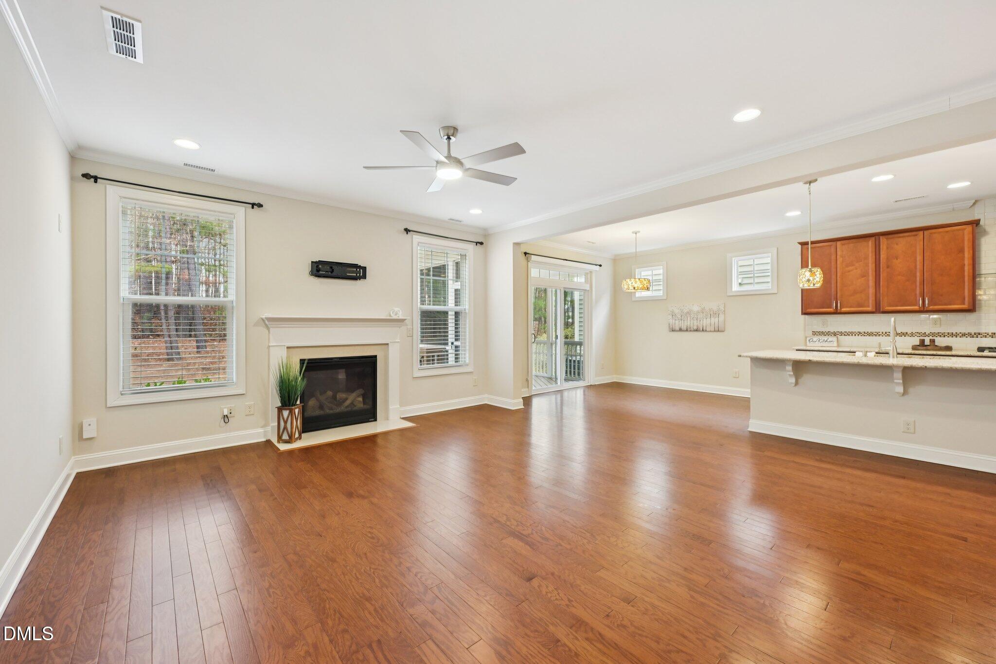 316 Rapport Drive Cary, NC 27519 - Photo 14 of 60 a view of an empty room with a fireplace and a window