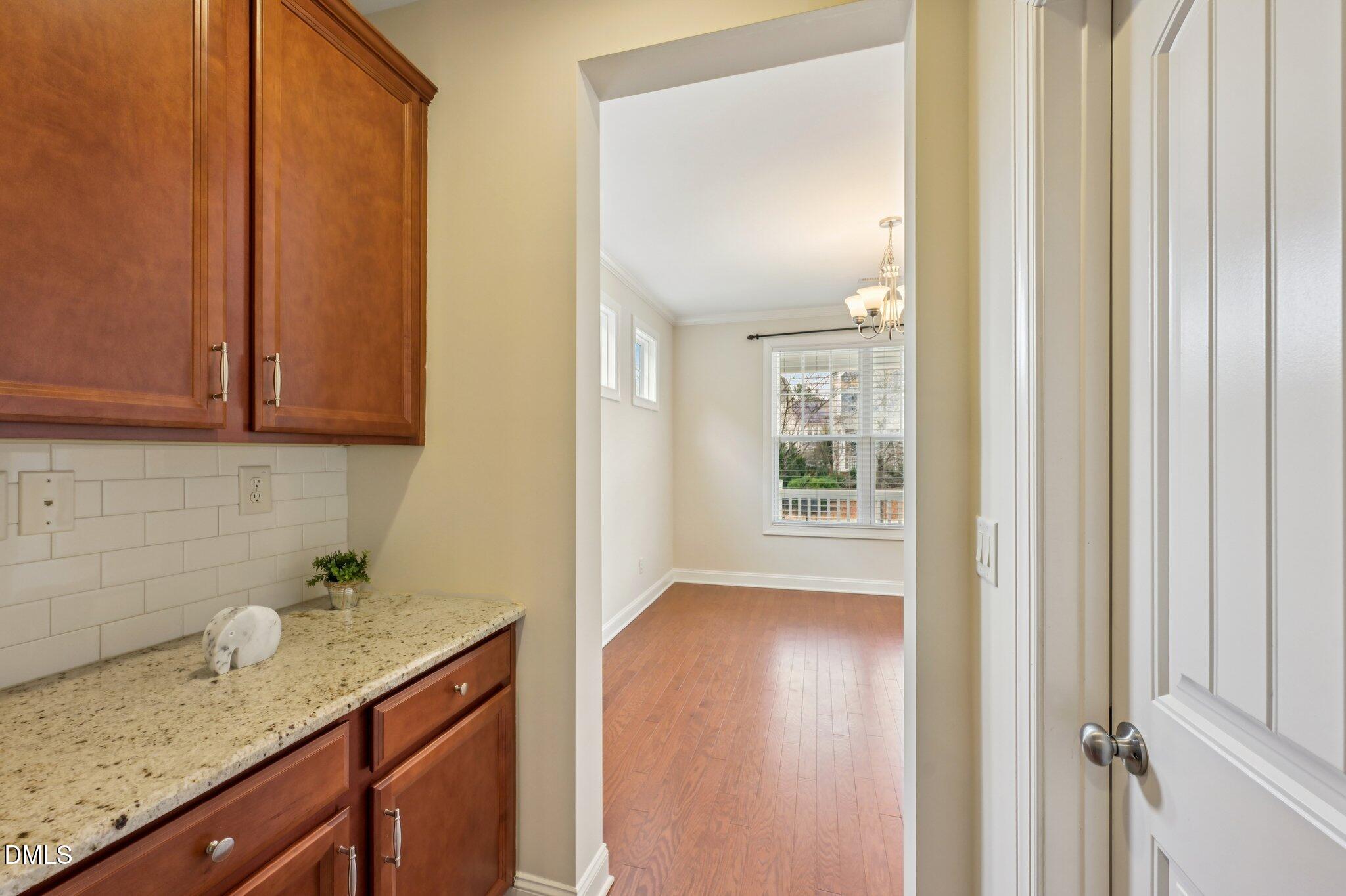 316 Rapport Drive Cary, NC 27519 - Photo 16 of 60 a view of hallway with sink and wooden floor