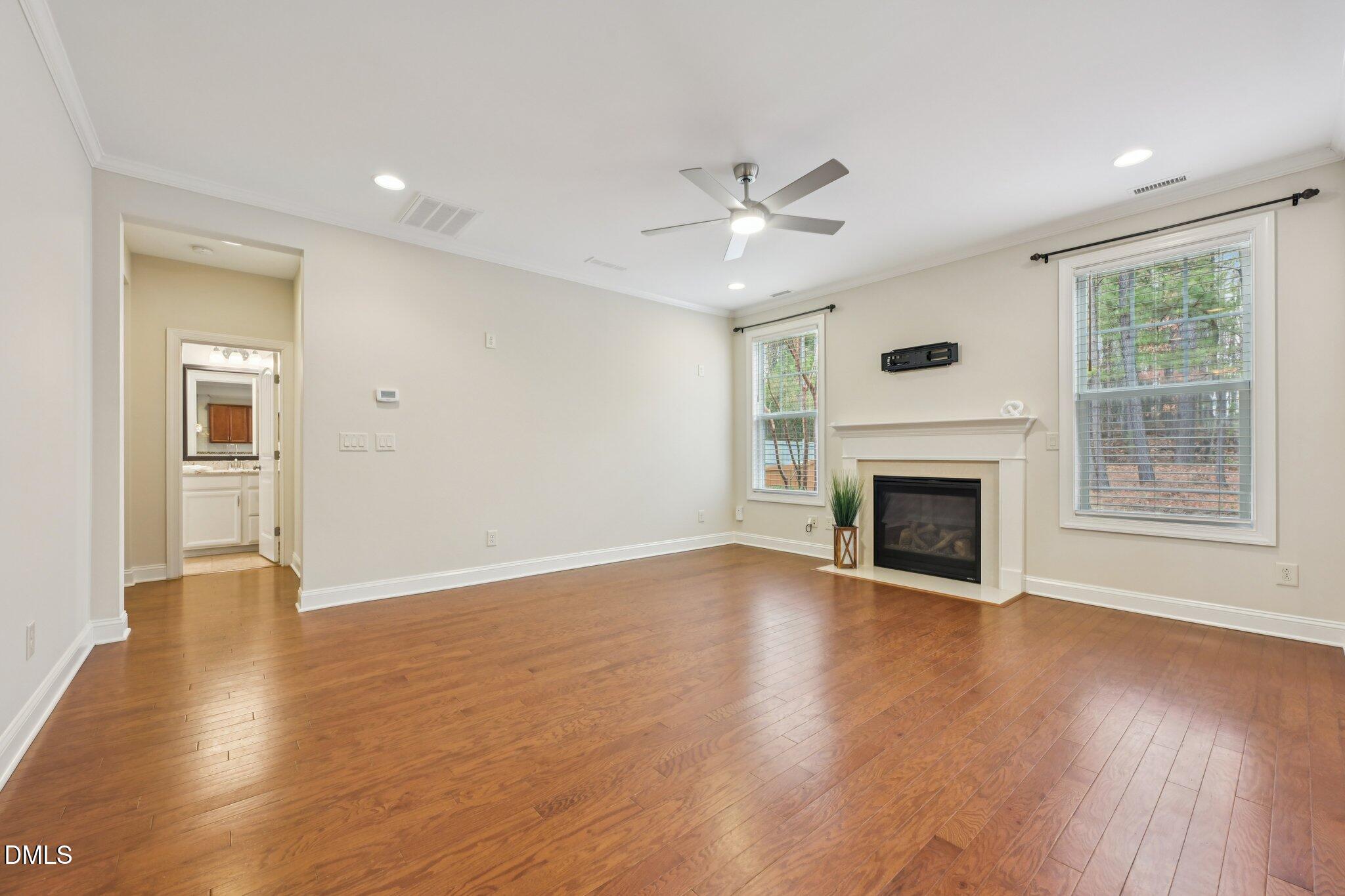 316 Rapport Drive Cary, NC 27519 - Photo 18 of 60 a view of an empty room with wooden floor and a window