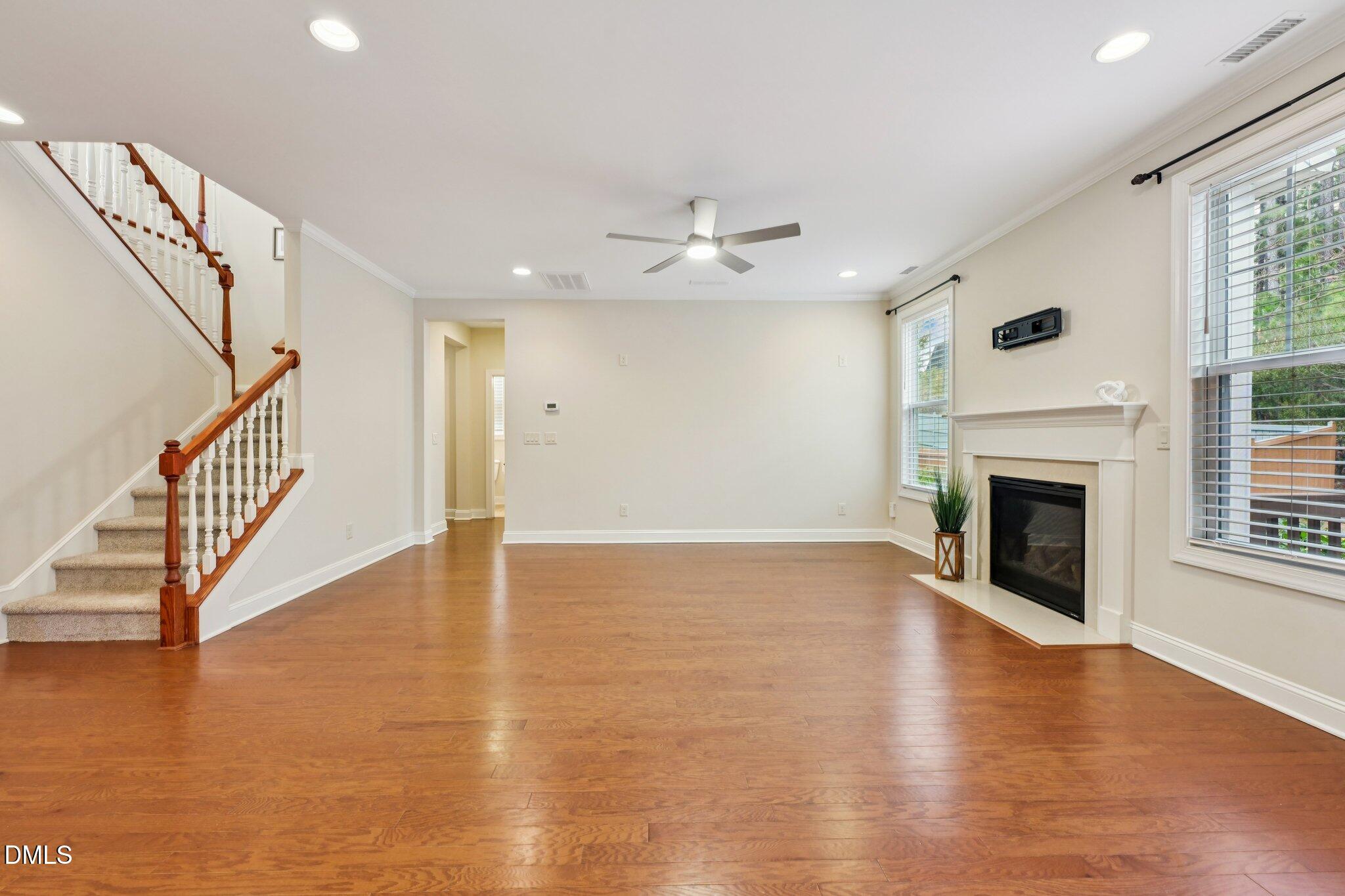 316 Rapport Drive Cary, NC 27519 - Photo 19 of 60 a view of an empty room with wooden floor fireplace and a window