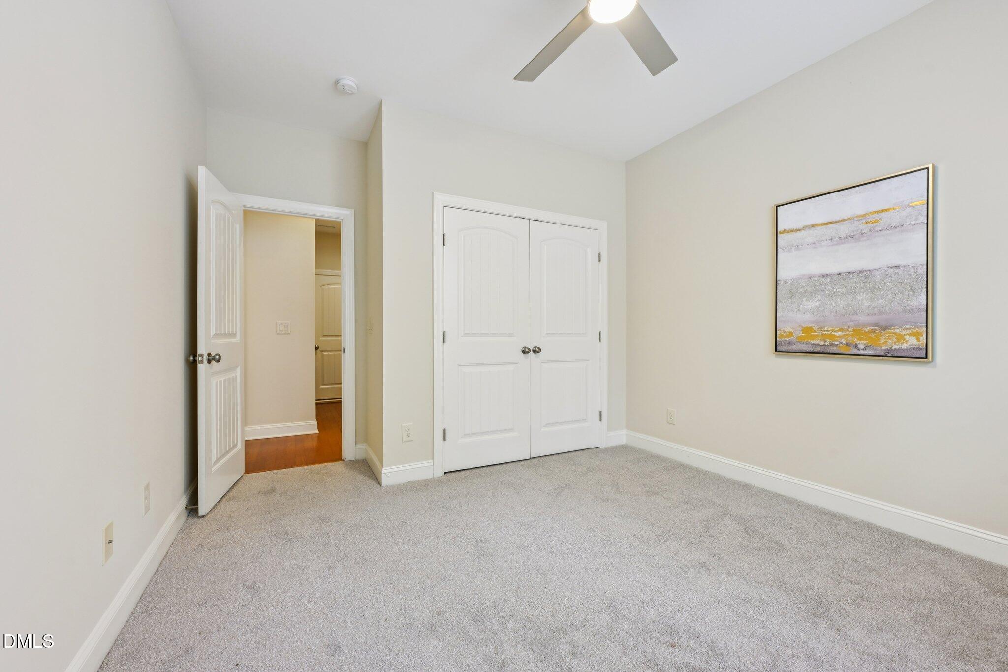 316 Rapport Drive Cary, NC 27519 - Photo 21 of 60 a view of an empty room with a ceiling fan