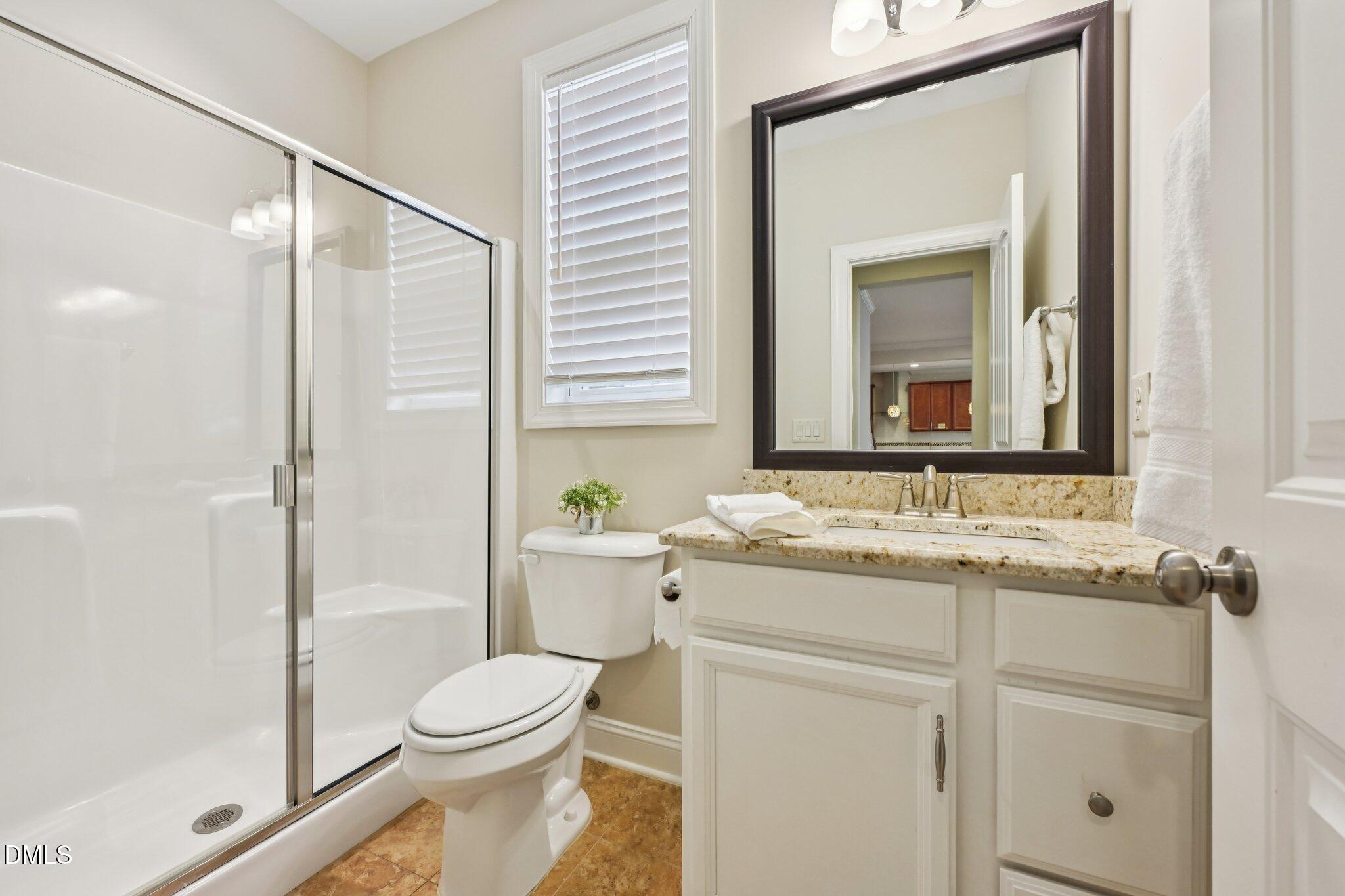 316 Rapport Drive Cary, NC 27519 - Photo 22 of 60 a bathroom with a granite countertop toilet sink and mirror