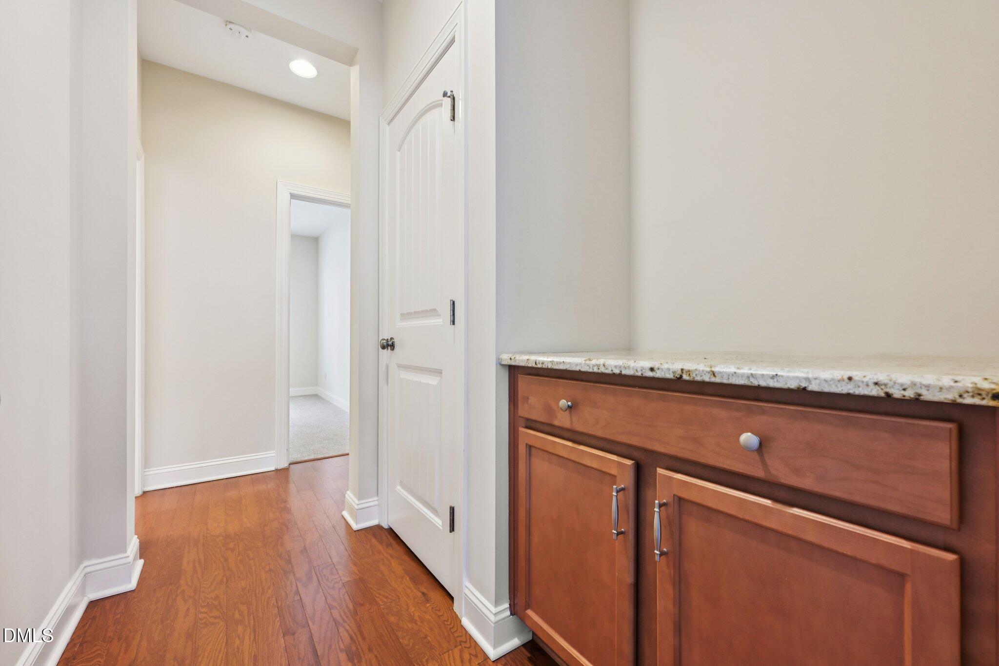 316 Rapport Drive Cary, NC 27519 - Photo 23 of 60 a view of an empty room with wooden floor and a potted plant