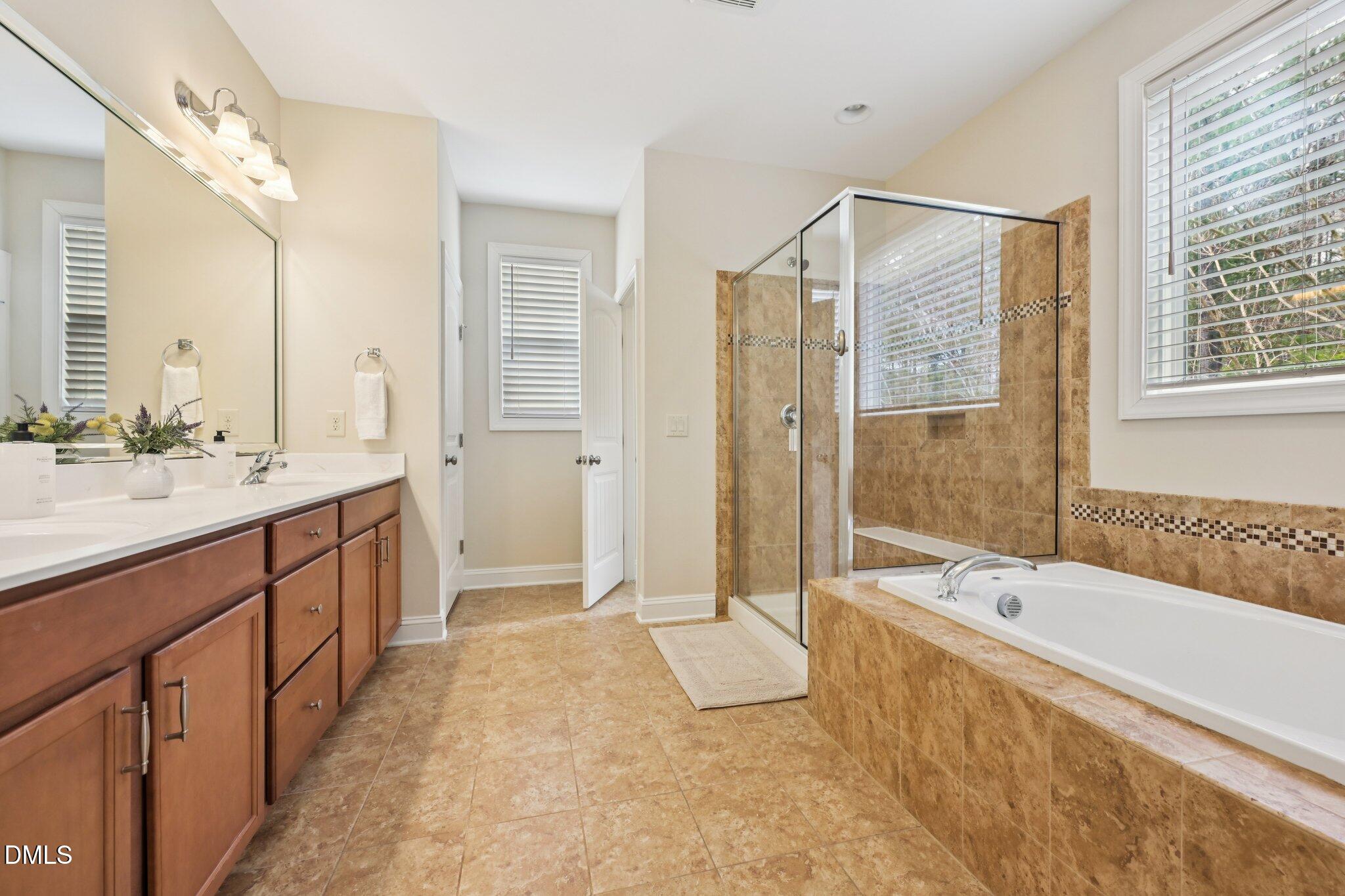 316 Rapport Drive Cary, NC 27519 - Photo 31 of 60 a spacious bathroom with a tub sink shower and mirror