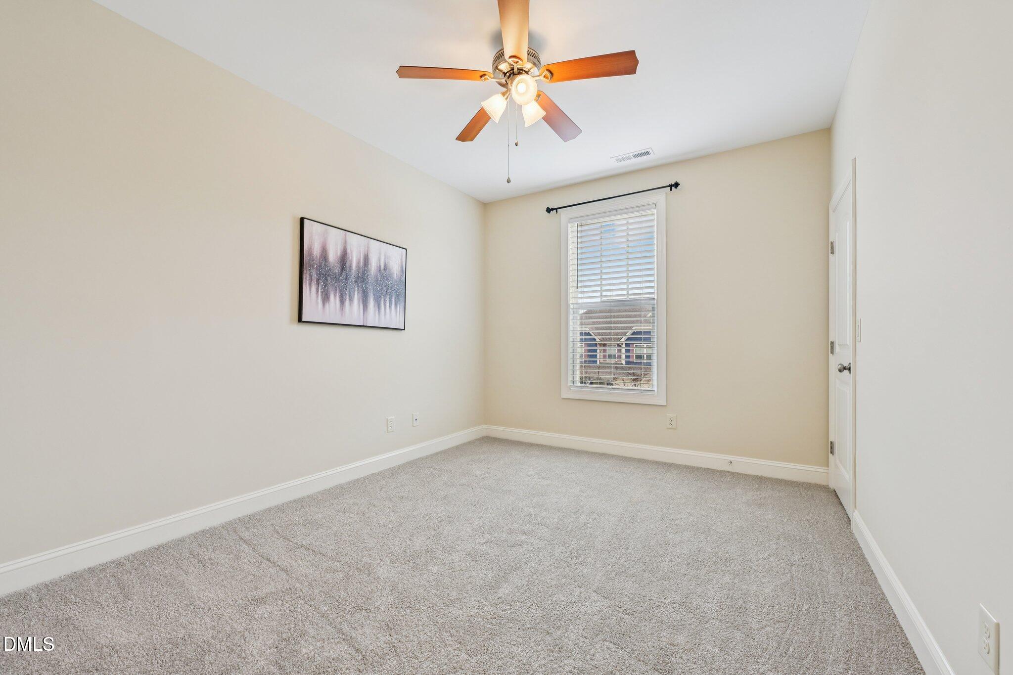 316 Rapport Drive Cary, NC 27519 - Photo 37 of 60 an empty room with windows and fan