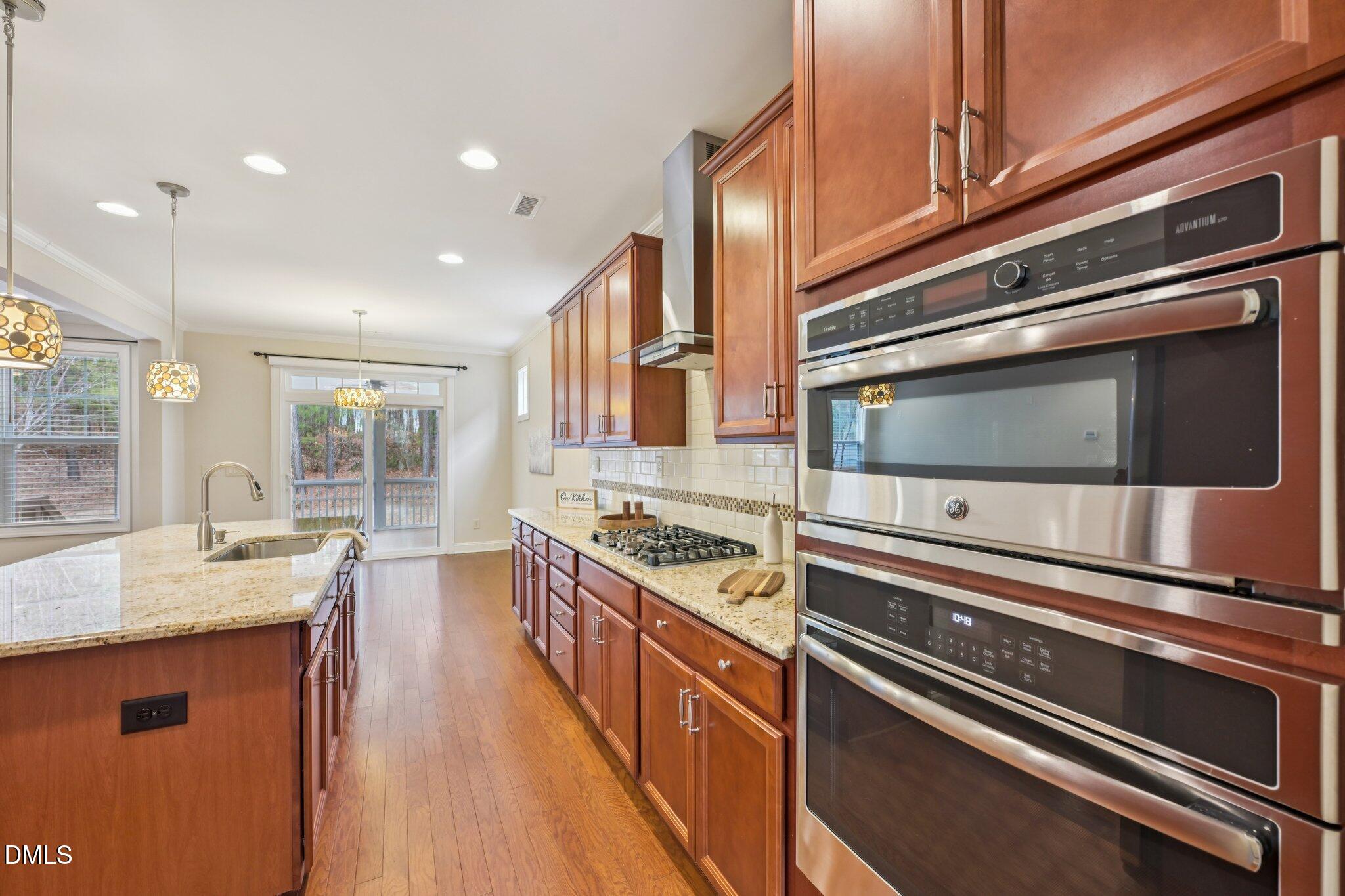 316 Rapport Drive Cary, NC 27519 - Photo 6 of 60 a kitchen with stainless steel appliances granite countertop a stove and a sink