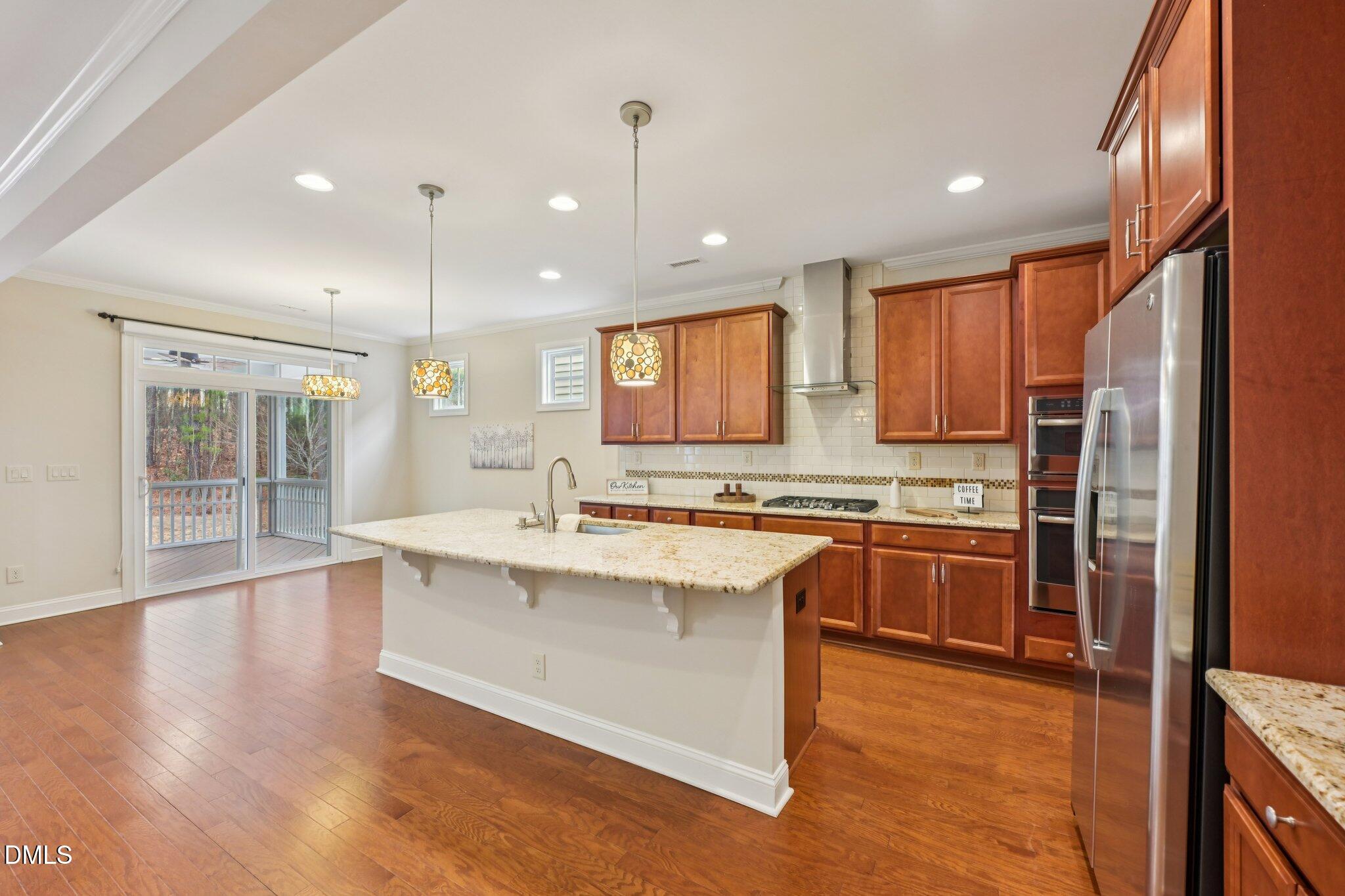 316 Rapport Drive Cary, NC 27519 - Photo 7 of 60 a large kitchen with stainless steel appliances granite countertop a stove a sink and a refrigerator