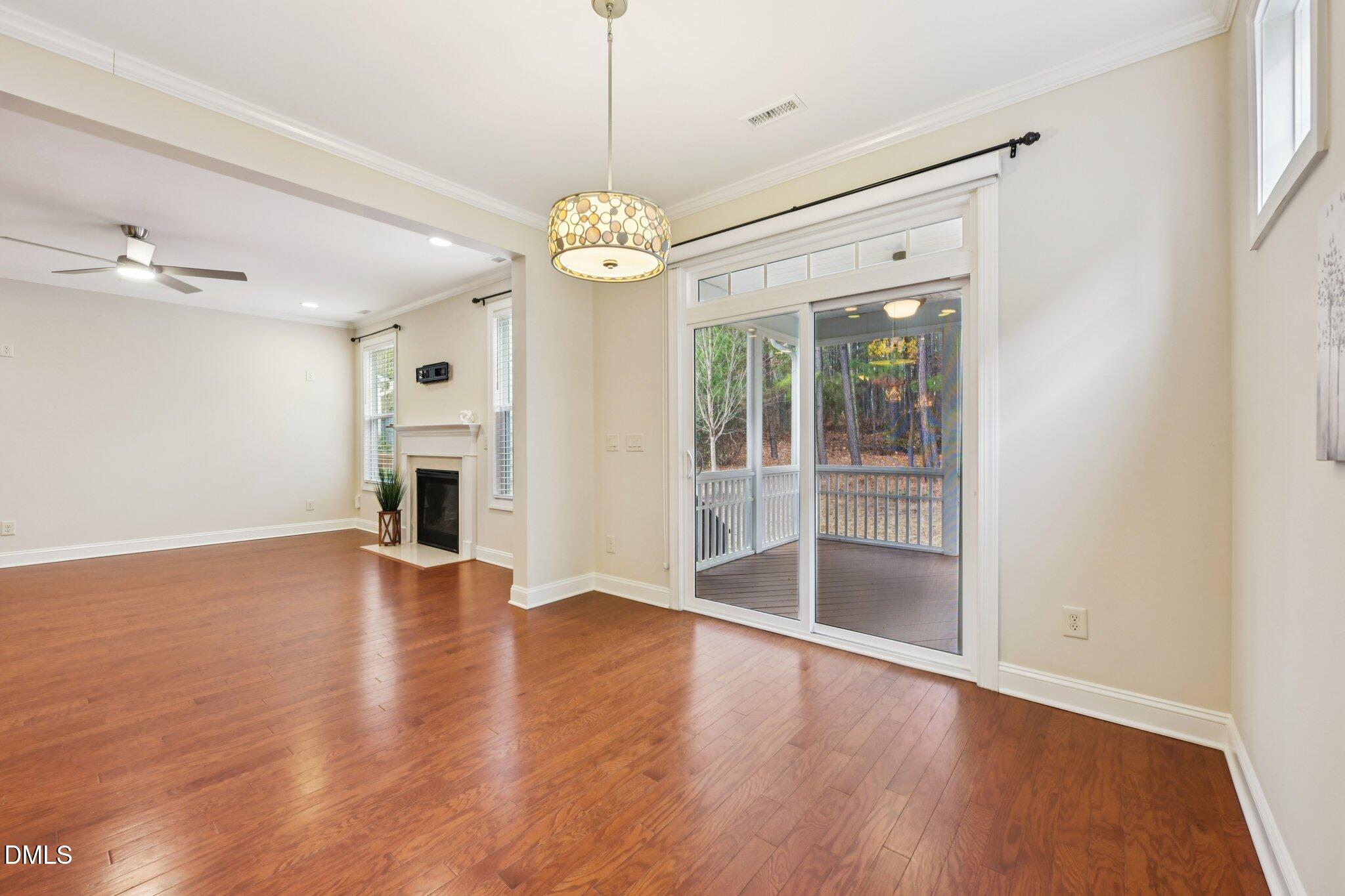 316 Rapport Drive Cary, NC 27519 - Photo 9 of 60 a view of a livingroom with a fireplace a ceiling fan and wooden floor