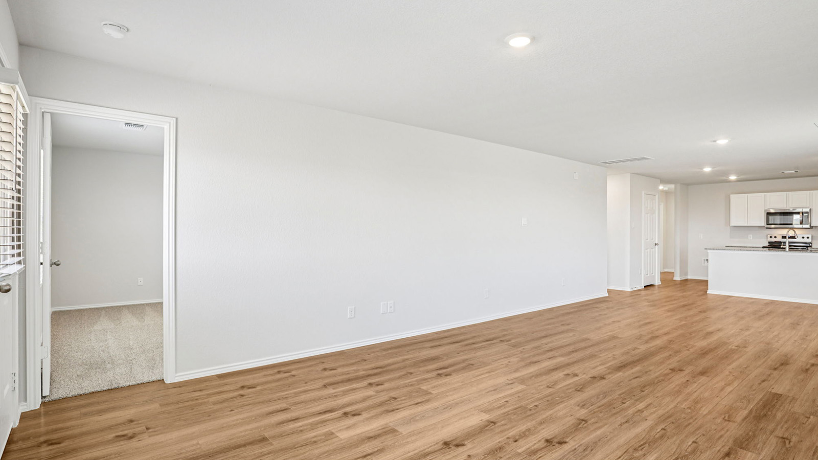 148 Wyatt Way Jarrell, TX 76537 - Photo 14 of 33 Open-concept living area featuring wood-finish flooring, recessed lighting, and a neutral color palette