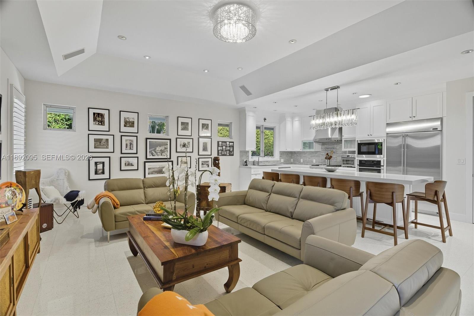 5800 Southwest 99th Terrace Pinecrest, FL 33156 - Photo 14 of 62 a living room with furniture kitchen and a table
