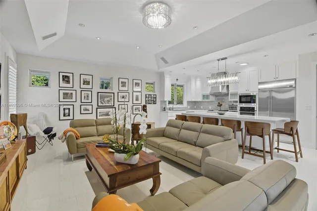 a kitchen with stainless steel appliances kitchen island granite countertop a refrigerator and a sink