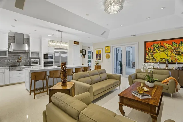 a spacious bedroom with a bed and a chandelier