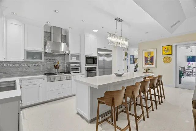 a spacious bedroom with a bed and a chandelier