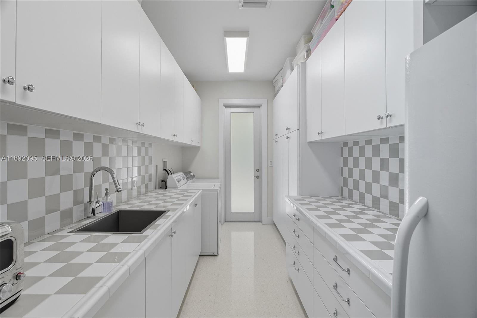5800 Southwest 99th Terrace Pinecrest, FL 33156 - Photo 18 of 62 a kitchen with a sink stove and refrigerator