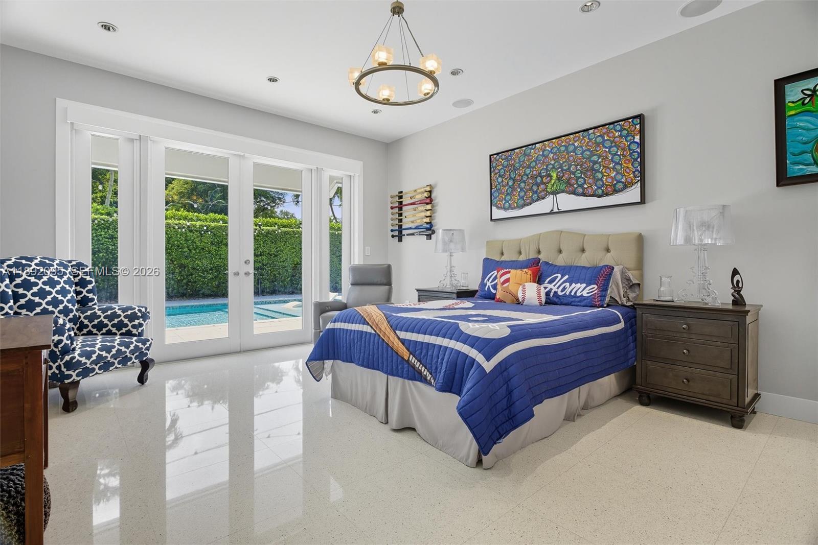 5800 Southwest 99th Terrace Pinecrest, FL 33156 - Photo 23 of 62 a bedroom with a large bed and a window